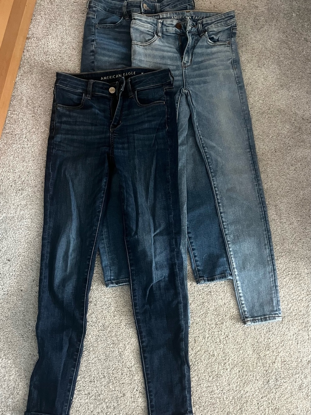 3 pairs of American Eagle Outfitters Women’s Mid- to Light-Wash Skinny Jeans